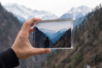 Hand holding a Summit Display acrylic block outdoors — example render
